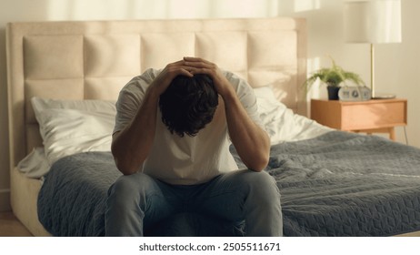 Unhappy Caucasian European man holding head problem crisis breakup male guy bedroom credit debt serious trouble hopelessness depressed grief despair difficulty disappointment sadness emotional stress - Powered by Shutterstock