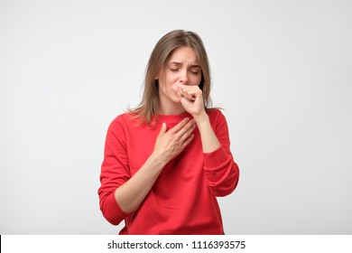 unhappy caucasian woman in red pulover suffering from throat pain at home. Concept of being ill and had a terrible feeling - Shutterstock ID 1116393575