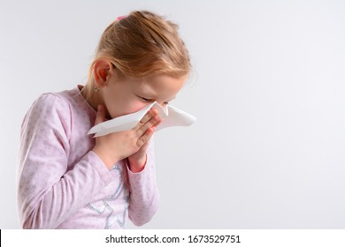 Unhappy Child Cough Into Her Elbow, Not Her Hand. Girl Pull The Collar Of Her T-shirt Up To Cover Mouth When Coughing. Coughing Advice From Experts Who Seek To Minimize Risk Of Viral Transmission