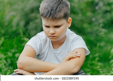 Unhappy Child Covering Her Face With Hands. Crying Boy Sitting Alone In Park. Depression, Stress, Frustration, Sadness, Bullying, Abuse, School Problems, Friends Misunderstanding With Kid In Preschool