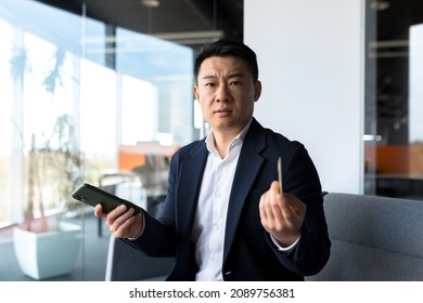 Unhappy Confused, Angry Asian Man Shopping Online. Customer Cannot Pay By Bank Credit Card. Having Problems Paying Feel Frustrated Stressed With Failed Transaction Internet On Computer Laptop Screen