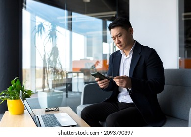 Unhappy Confused, Angry Asian Man Shopping Online. Customer Cannot Pay By Bank Credit Card. Having Problems Paying Feel Frustrated Stressed With Failed Transaction Internet On Computer Laptop Screen