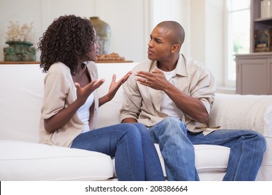 Unhappy Couple Arguing On The Couch At Home In The Living Room