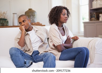Unhappy couple arguing on the couch at home in the living room