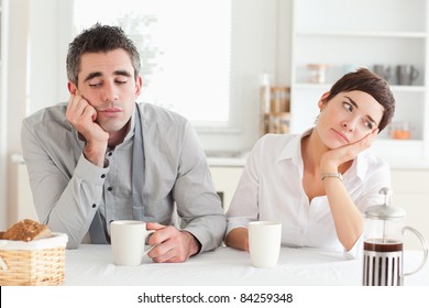 Unhappy Couple Drinking Coffee In A Kitchen