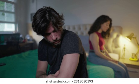 Unhappy couple feeling disconnected from each other. Man and woman sitting in bed ignoring each other - Shutterstock ID 2313080193