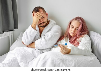 Unhappy Couple Found Out About Pregnancy, Lie On Bed In The Morning, Look At Test, Dissatisfied With Unplanned, Unwanted Pregnancy