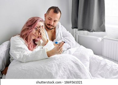 Unhappy Couple Found Out About Pregnancy, Lie On Bed In The Morning, Look At Test, Dissatisfied With Unplanned, Unwanted Pregnancy