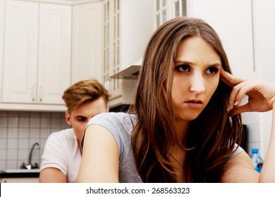 Unhappy Couple Having An Argument In The Kitchen At Home.