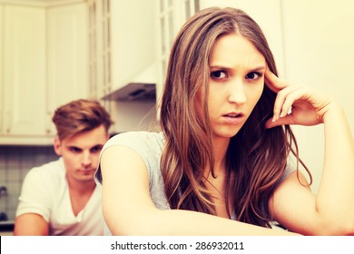 Unhappy Couple Having An Argument In The Kitchen At Home.