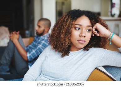 Unhappy couple and sad woman upset after argument or conflict with her man on home sofa. Angry girlfriend or female thinking about disagreement or ignoring partner, tired of relationship problems. - Shutterstock ID 2188062357