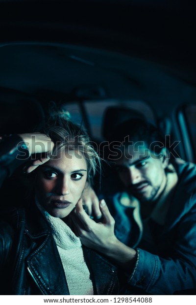 Unhappy couple\
sitting in the car and\
discussing