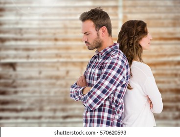 Unhappy Couple Standing Back To Back Against Wooden Background