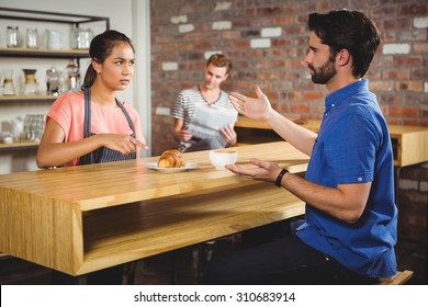 Unhappy Customer Complaining About The Croissant In A Cafe