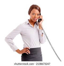 An Unhappy Customer. An Upset Business Woman With Her Hands On Her Hip Talking On The Phone.