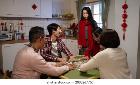 Unhappy Daughter Losing To Brother In Musical Chair Game And Staring At Him Feeling Unfair. Disqualified From Playing Mahjong On Chinese New Year's Eve. Translation: Luck