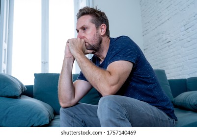 Unhappy Depressed Caucasian Male Crying In Living Room Couch Feeling Desperate And Lonely Isolated At Home. In Stressed From Work, Unemployment, Anxiety, Heartbroken And Depression Concept