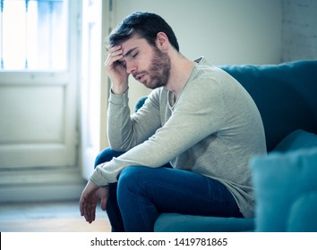 Unhappy depressed caucasian male sitting and lying in living room couch feeling desperate a lonely suffering from depression. In stressed from work, anxiety, heartbroken and men Health care concept. - Shutterstock ID 1419781865