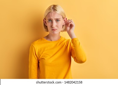 unhappy depressed woman doesn't like her big ears, close up photo. appearance concept,girl has problem with hearing