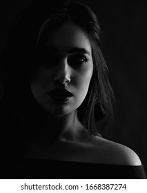 Unhappy Depression Young Woman Looking. Closeup Portrait In Dark Shadow. Art. Black And White