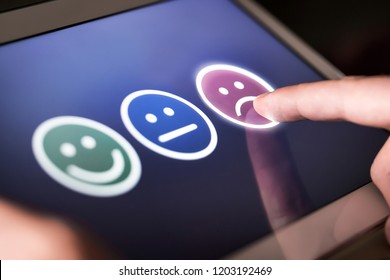 Unhappy and disappointed customer giving low rating and negative feedback in survey, poll or questionnaire. Sad and dissatisfied man giving review about service quality. Bad user experience. - Shutterstock ID 1203192469