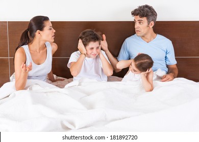 Unhappy Family Arguing Parents In A Bed, Couple Man And Woman With Children Having Conflict Problem, Upset Sad Negative Emotions Concept