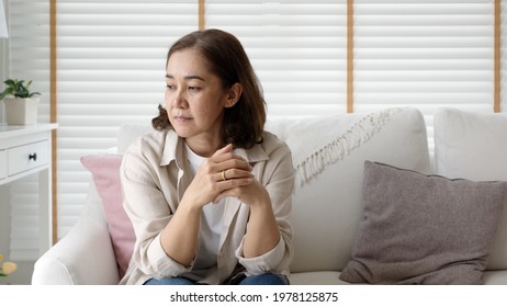 Unhappy Female employee latin mom think sit sofa couch at home living room need help support panic coronavirus financial debt crisis in life insurance feel pain distress pensive regret lost upset.