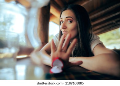
Unhappy Girlfriend Pushing Away Engagement Ring Refusing Proposal. Uninterested woman rejecting a gift from her ex-partner
