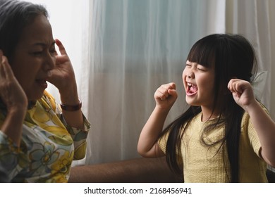 Unhappy Grandmother Having Problem With Noisy Naughty Little Granddaughter Screaming. Naughty Difficult Rebellious Child Girl Problems