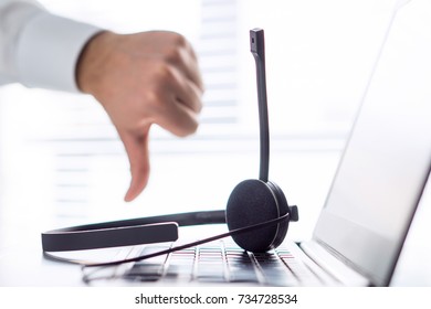 Unhappy Help Desk, Support Hotline Or Call Center Person Showing Thumbs Down. Tele Marketing Professional Having Horrible Day, Not Satisfied. Bad Feedback Or Working Conditions.