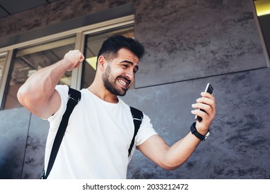 Unhappy Hipster Guy Feeling Angry During Mobile Messaging With Customer Service, Caucaisan Male Blogger Reading Received Email Text On Modern Smartphone Technology Solving Problems At City Street