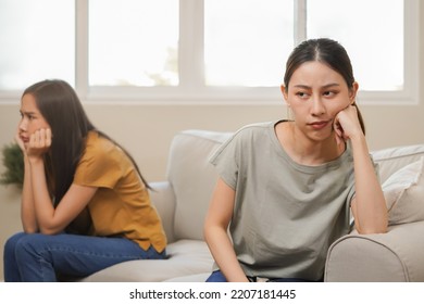 Unhappy Lesbian, Lgbt Asian Young Two Women, Girl Gay, Couple Love Fight On Sofa, Relationship Is In Trouble. Different People Are Angry And Use Emotions At Each Other, Expression Of Disappointmen.