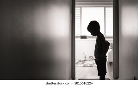 unhappy little boy silhouette indoors 