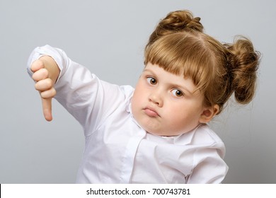 Unhappy Little Girl Showing Thumb Down Gesture Isolated