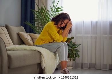 Unhappy Lonely Depressed Woman At Home, She Is Sitting On The Couch, Depression Concept