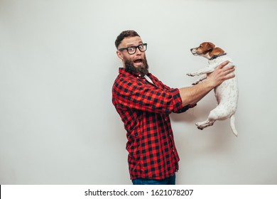 Unhappy Male With Beard Holding His Dirty Dog. Bad Smell Pet Needs To Be Washed.