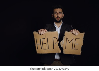 Unhappy Man With HELP ME Sign On Dark Background