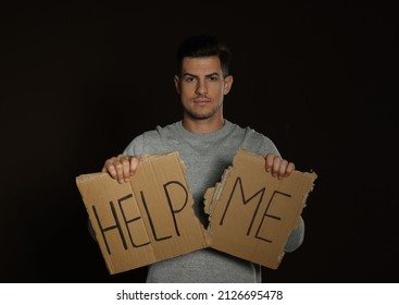 Unhappy Man With HELP ME Sign On Dark Background