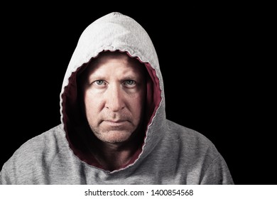 Unhappy Man In Hoodie. Isolated On Black.