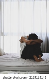 Unhappy Man Sitting In The Dark Bedroom With Low Light Environment. Mental Health, Depression, Sad Emotional, Mental Illness