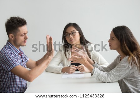 Unhappy married couple get divorced arguing fighting in lawyer office, disappointed husband refusing to pay alimony or sign decree paper, custody battle, family separation, divorce settlement concept Stock photo © 