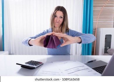 Unhappy Mature Woman Shows Her Empty Purse In Office