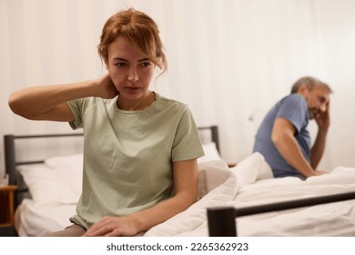 Unhappy middle aged couple in bedroom at home - Powered by Shutterstock