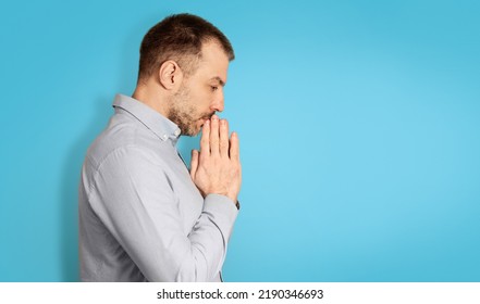 Unhappy Middle Aged Man Thinking About His Problems Holding Hands Near Face Standing Over Blue Studio Background. Male Depression Concept. Empty Space For Text, Side View Shot