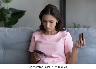 Unhappy millennial ethnic female buyer or client confused by cancelled unsuccessful payment with credit card on smartphone. Upset indian Arabic woman frustrated by mistake shopping online on cell.