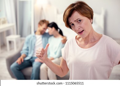 Unhappy Mother In Law. Cheerless Aged Woman Looking At You While Worrying About Her Son