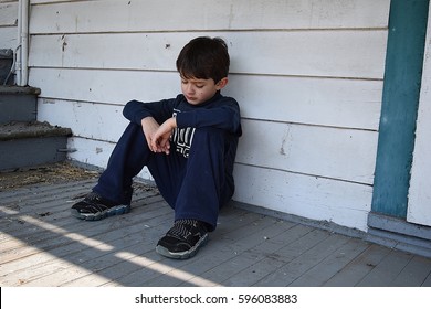 Unhappy neglected child outside home