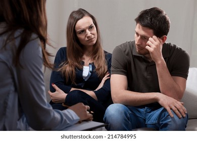 Unhappy at odds couple sitting on psychotherapy session