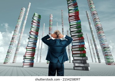An unhappy office worker, a businessman, looks at the towers from many folders with documents. Concept of hard work, busy clerk, recycling, bureaucracy. mixed media.