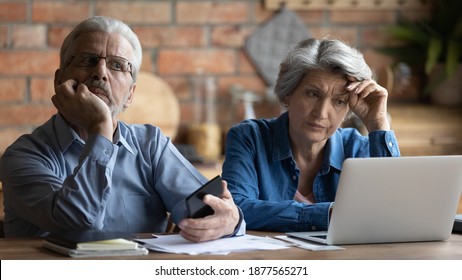 Unhappy Older Senior Family Couple Thinking Of Financial Problems, Feeling Stressed Of Banking Debt Notification Or Not Enough Money While Calculating Budget Together At Home, Bankruptcy Concept.